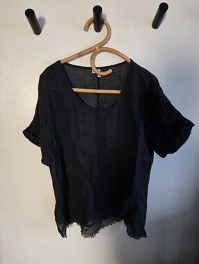 Black linen short-sleeve top featuring a loose fit, rolled sleeves, frayed hem L
